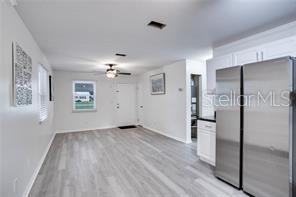 3916 Broad Street Seffner, FL 33584 - Photo 3 of 9 a view of a kitchen with wooden floor and a refrigerator