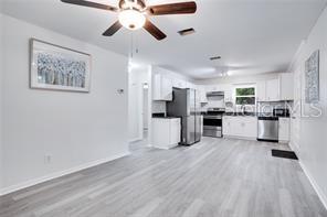 3916 Broad Street Seffner, FL 33584 - Photo 5 of 9 a view of kitchen with stainless steel appliances refrigerator stove microwave and cabinets