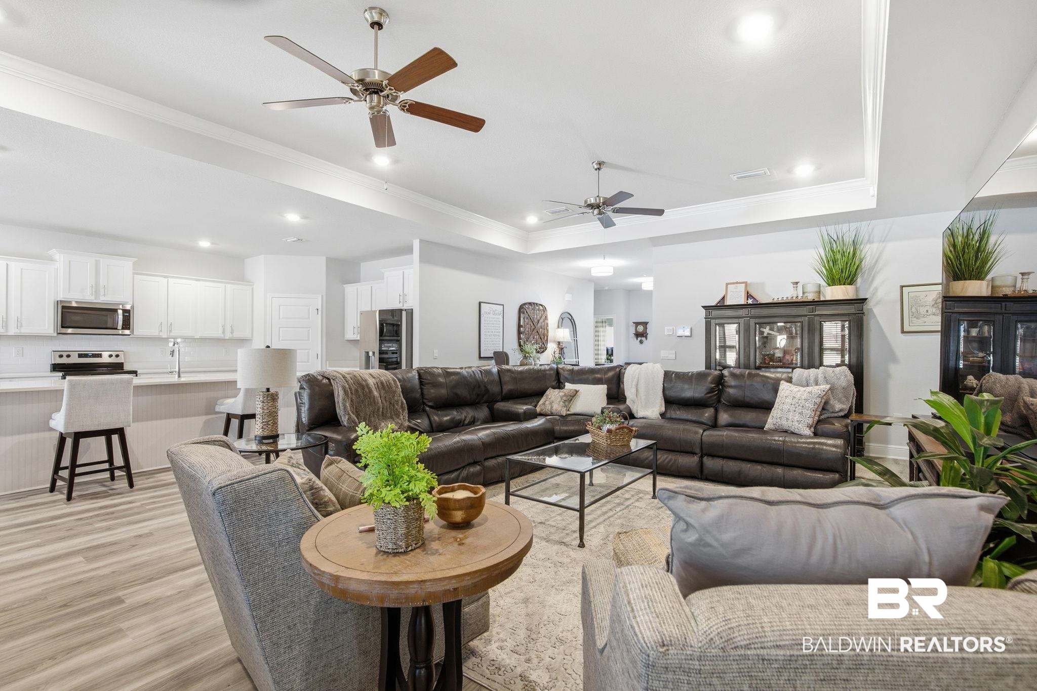 11123 Genuine Risk Circle Daphne, AL 36526 - Photo 13 of 67 Living room with crown molding, a ceiling fan, light wood-style flooring, recessed lighting, and a tray ceiling
