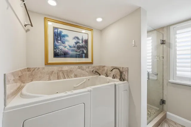 a view of a hallway with living room and wooden floor
