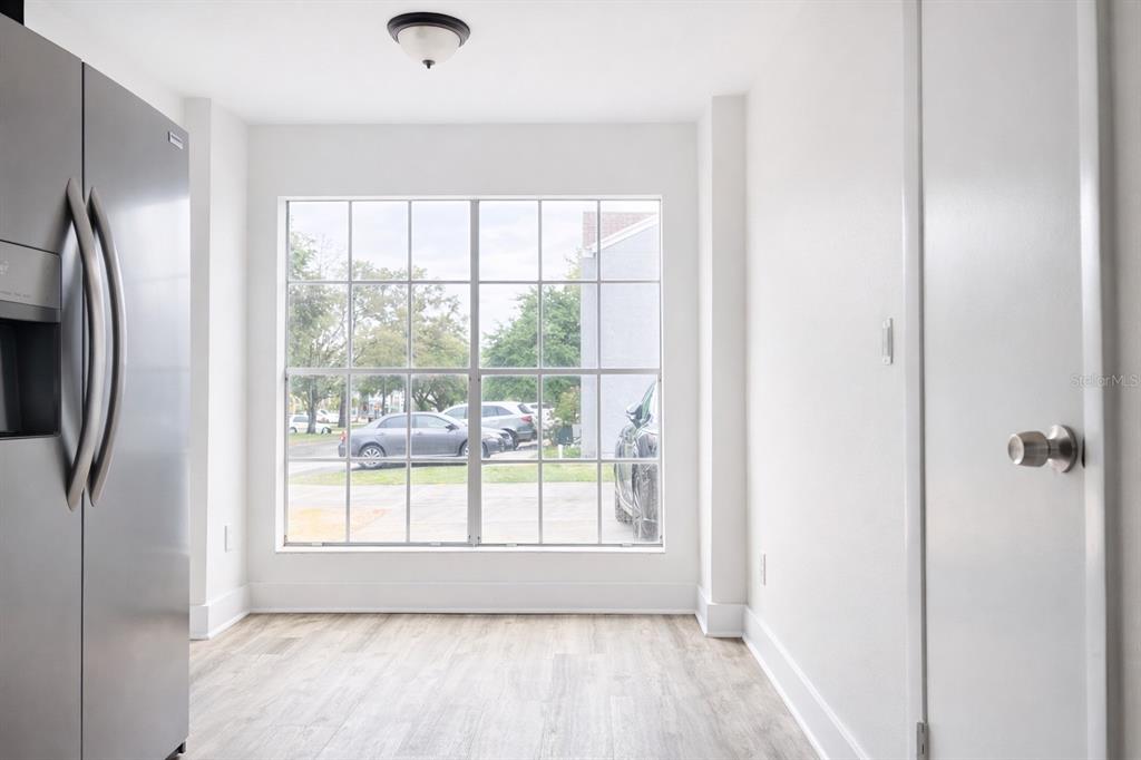 11008 Yorkshire Ridge Court Orlando, FL 32837 - Photo 11 of 24 a view of a livingroom with a white door and wooden floor