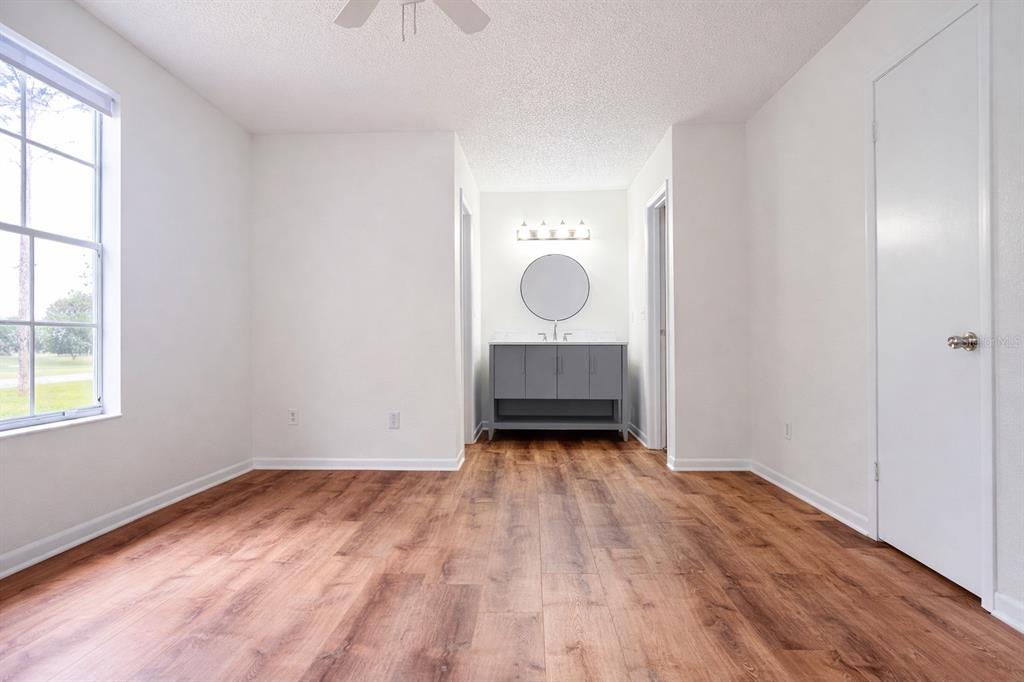 11008 Yorkshire Ridge Court Orlando, FL 32837 - Photo 13 of 24 an empty room with wooden floor and window