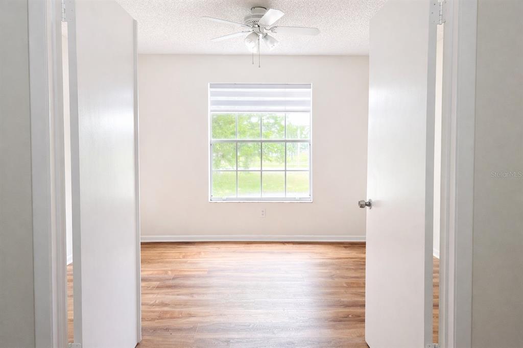 11008 Yorkshire Ridge Court Orlando, FL 32837 - Photo 14 of 24 a view of a room with wooden floor and a window