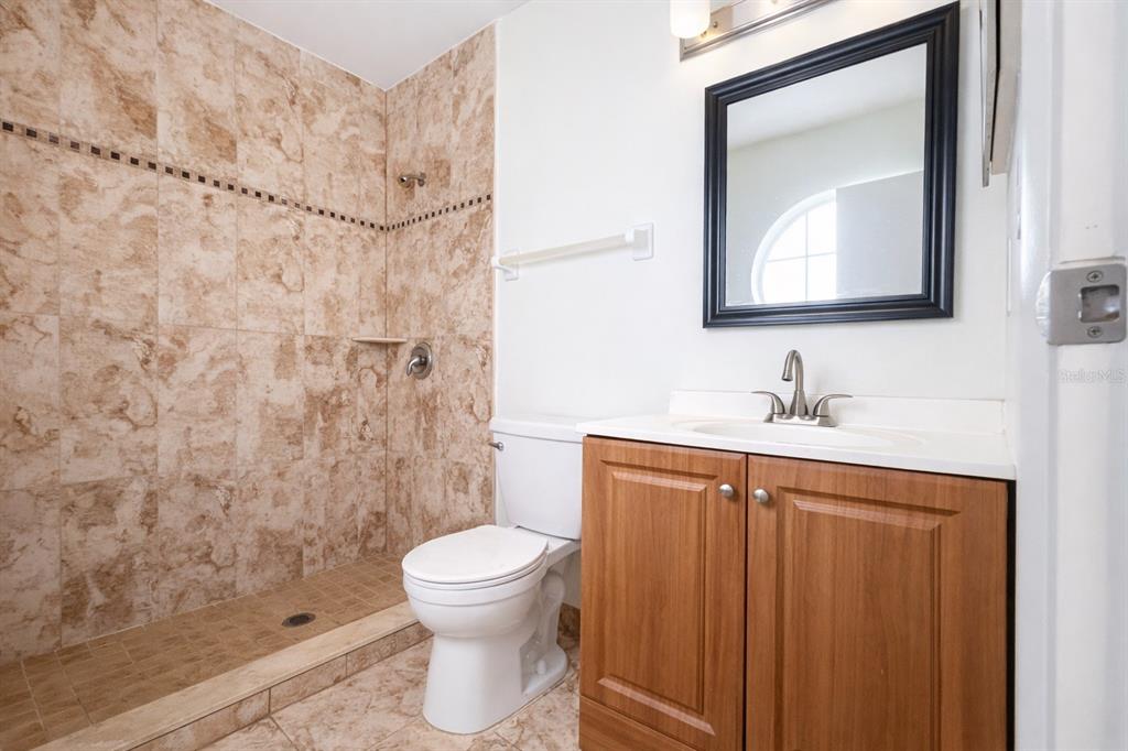 11008 Yorkshire Ridge Court Orlando, FL 32837 - Photo 20 of 24 a bathroom with a sink toilet and shower