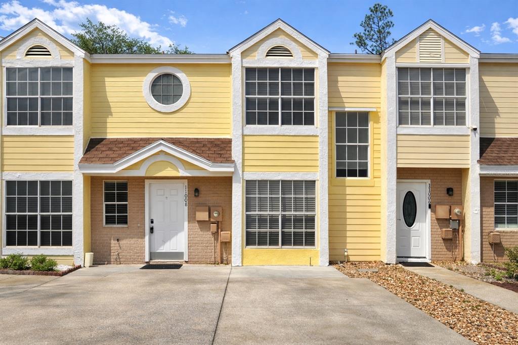 11008 Yorkshire Ridge Court Orlando, FL 32837 - Photo 2 of 24 a view of a house with wooden fence and large windows