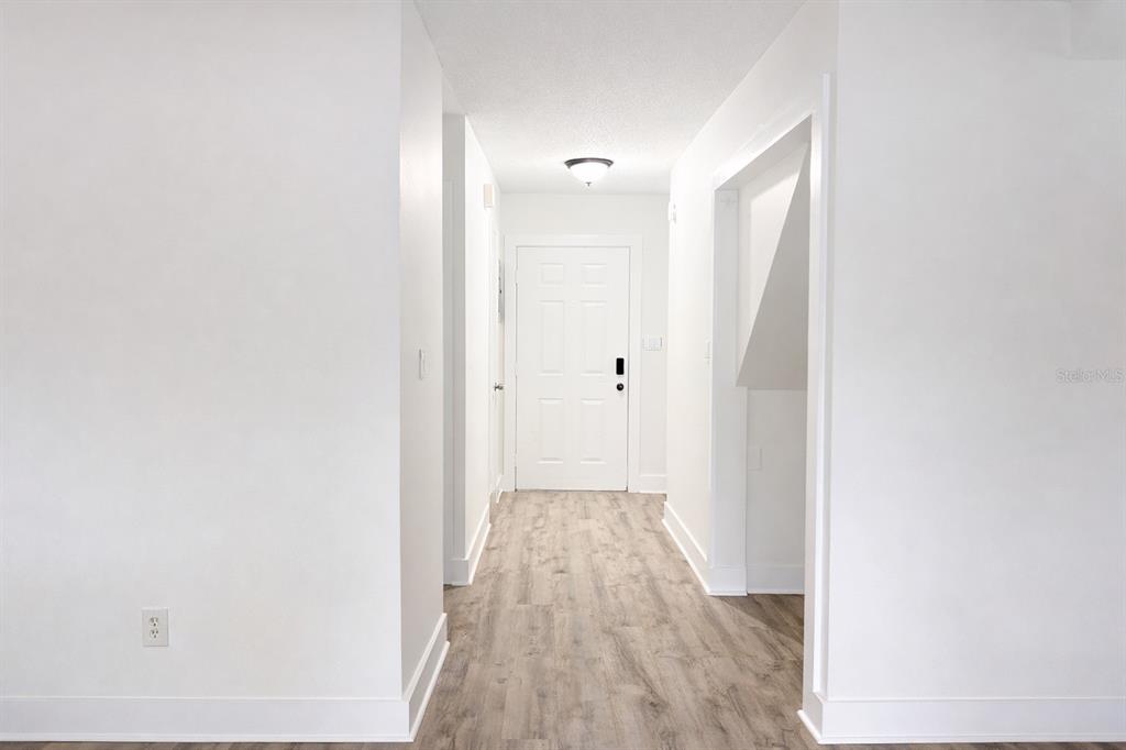 11008 Yorkshire Ridge Court Orlando, FL 32837 - Photo 7 of 24 a view of a hallway with wooden floor