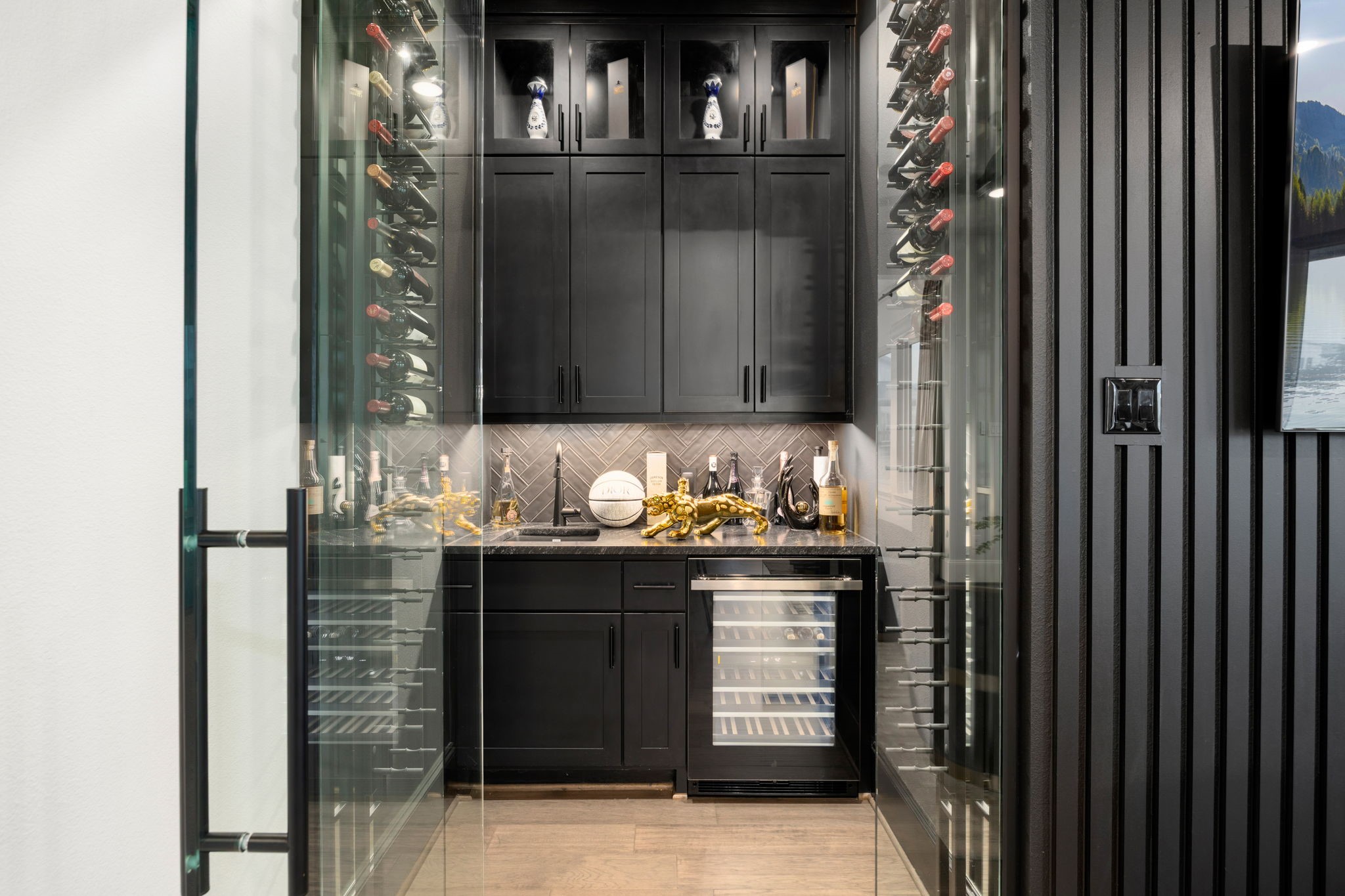 29419 Cir S Rnch Trail Fulshear, TX 77406 - Photo 5 of 45 Things We Love #3- This custom temperature-controlled wine cellar nook and wet bar offers a sophisticated glass entry layout, modern rack storage, custom dark cabinetry, and a separate beverage fridge.