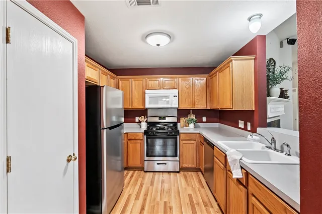 a kitchen with a sink appliances and cabinets