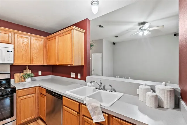 a kitchen with a sink cabinets and appliances