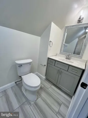 a white toilet sitting next to a bathroom sink