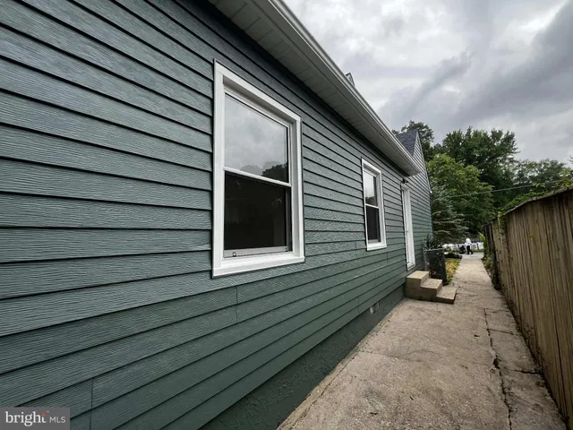 a house that has a tree in front of it