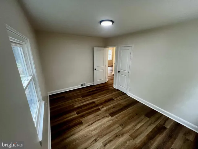 a view of an empty room and wooden floor