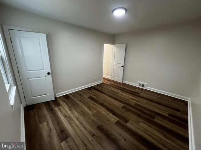 a view of room with wooden floor