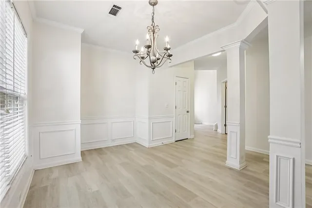 a view of empty room with wooden floor and ceiling window