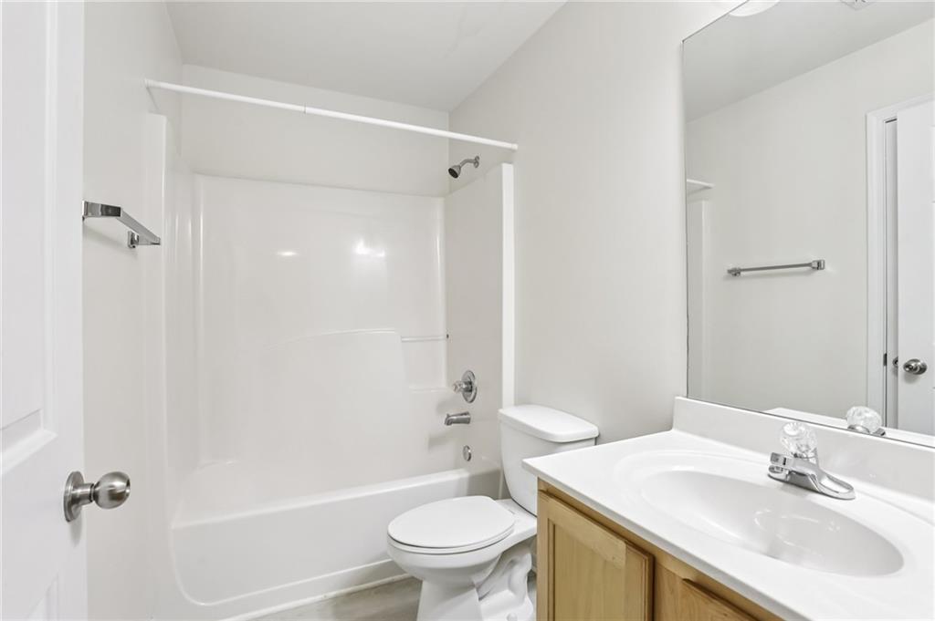 5940 Bentley Way Cumming, GA 30040 - Photo 22 of 39 a bathroom with a sink toilet and shower