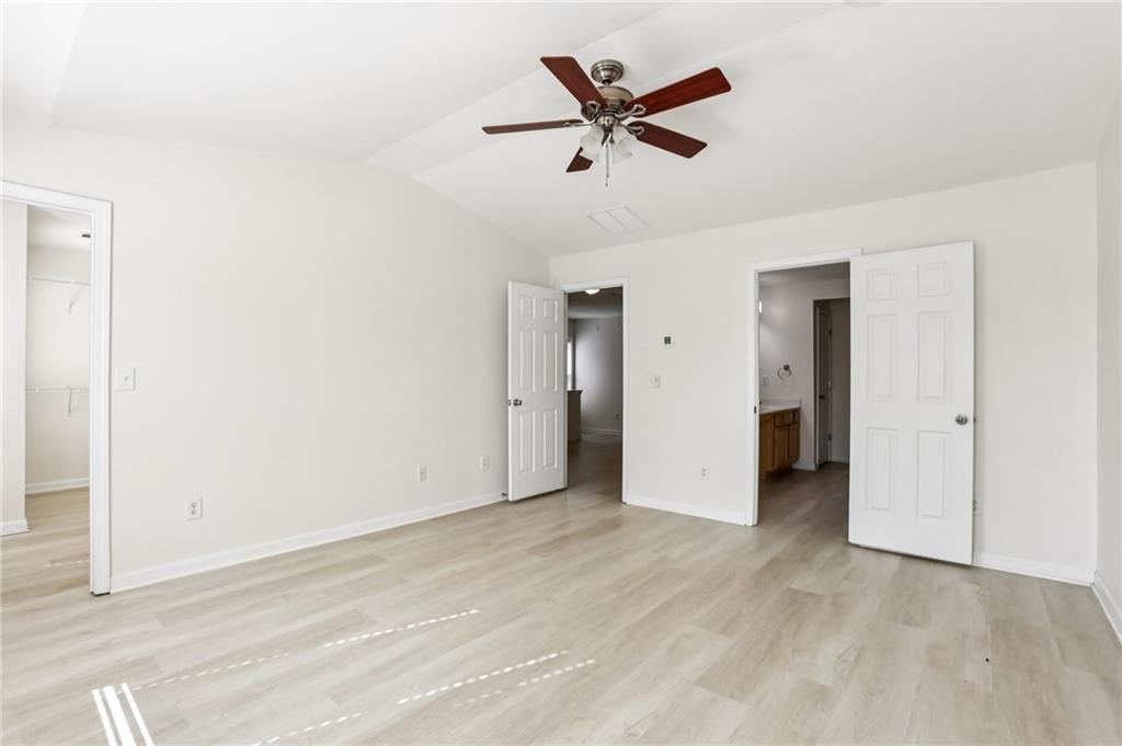 5940 Bentley Way Cumming, GA 30040 - Photo 25 of 39 an empty room with closet and a ceiling fan