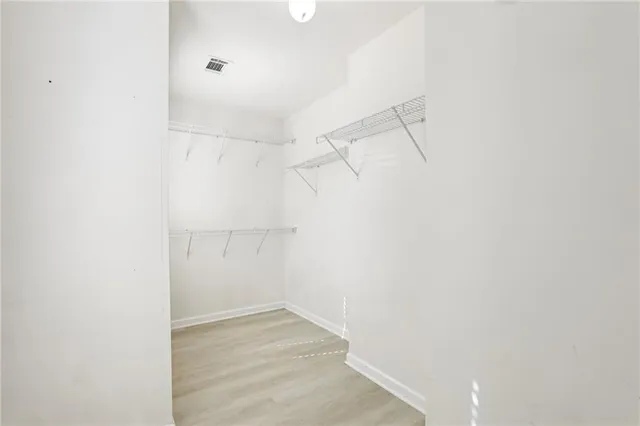 a spacious bathroom with a tub sink and mirror
