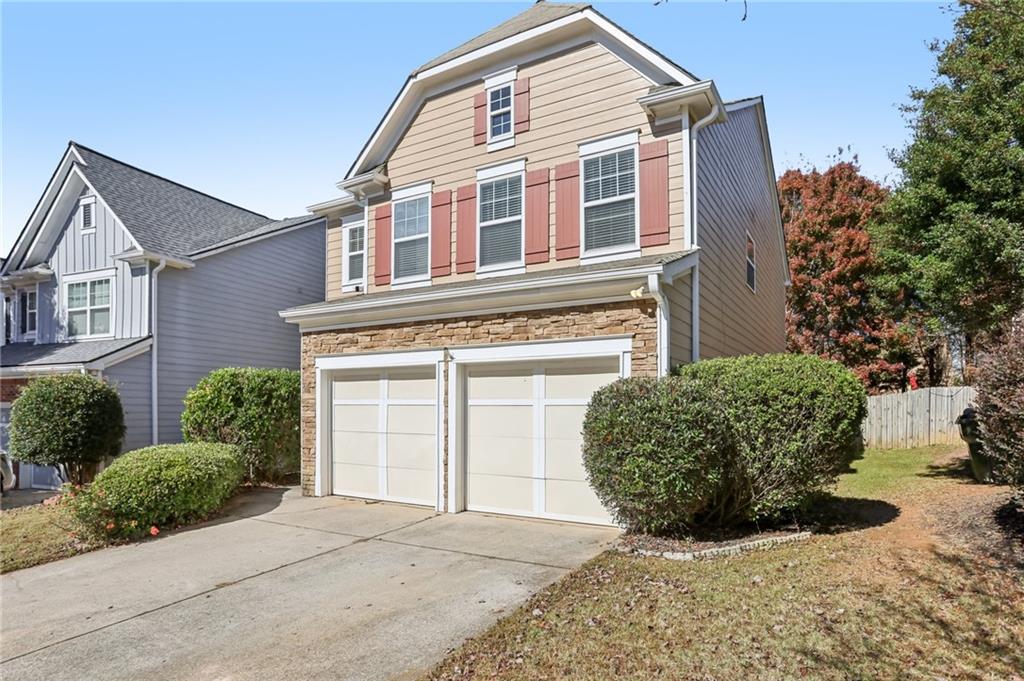 5940 Bentley Way Cumming, GA 30040 - Photo 3 of 39 a front view of a house with a yard