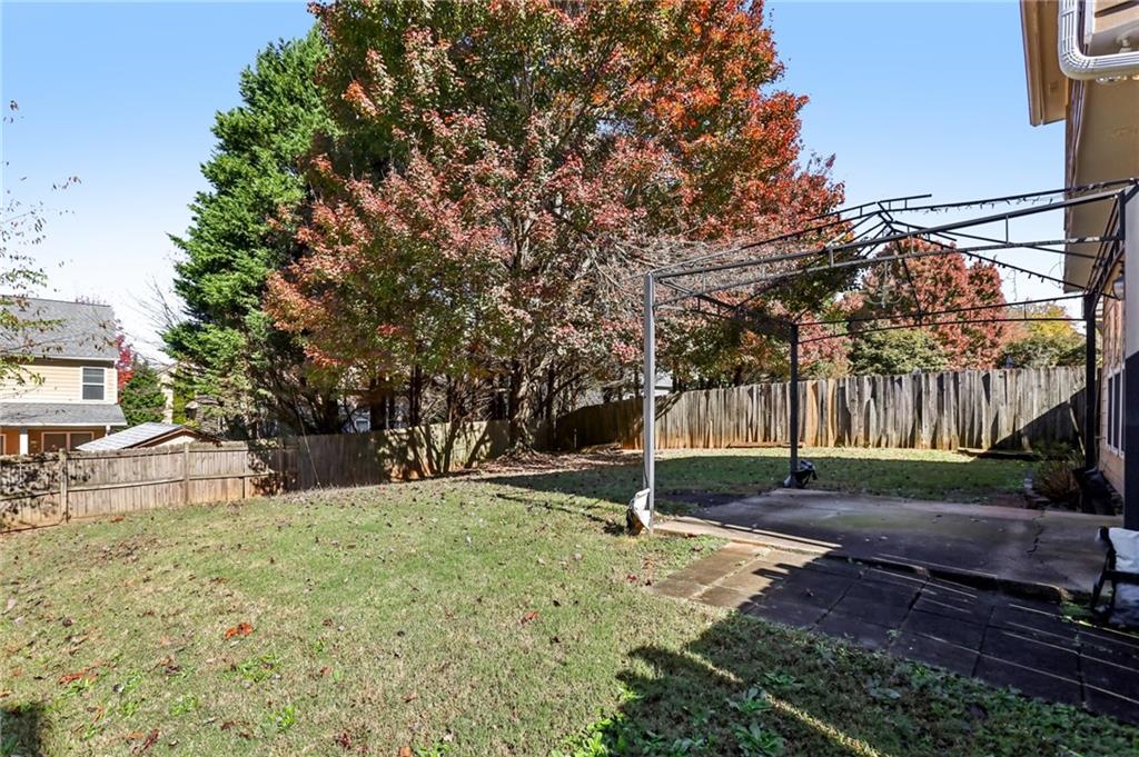 5940 Bentley Way Cumming, GA 30040 - Photo 34 of 39 a view of a yard with a tree
