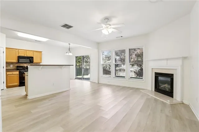 a view of a kitchen with a sink dishwasher and a fireplace