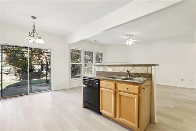 a kitchen with stainless steel appliances granite countertop a stove and cabinets