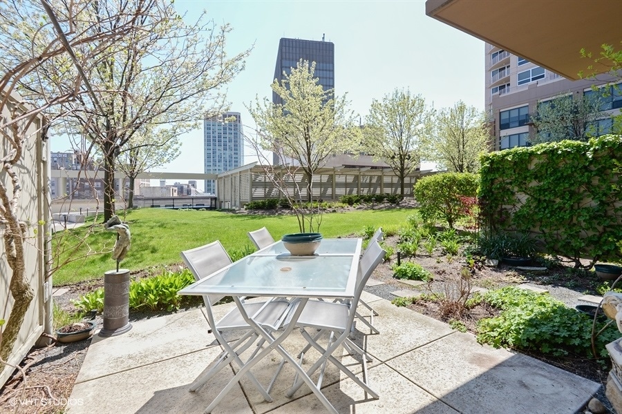 807 Davis Street, Unit 314 Evanston, IL 60201 - Photo 12 of 27 a view of a chairs and table in backyard