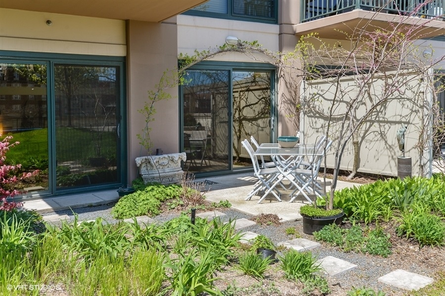 807 Davis Street, Unit 314 Evanston, IL 60201 - Photo 13 of 27 a view of a porch with a table and chairs