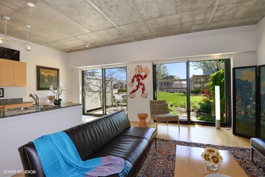 807 Davis Street, Unit 314 Evanston, IL 60201 - Photo 6 of 27 a living room with furniture large windows and wooden floor