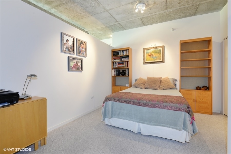 807 Davis Street, Unit 314 Evanston, IL 60201 - Photo 9 of 27 a bedroom with a bed and a cabinets