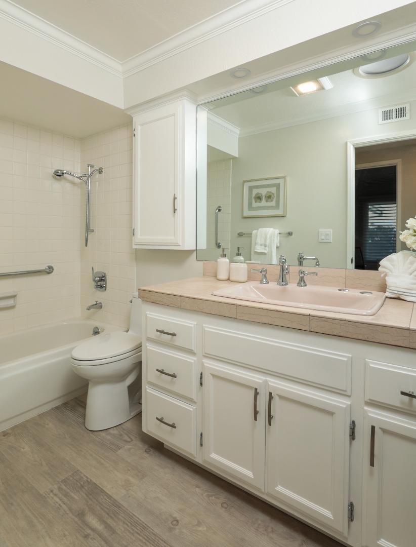 4057 Ashbrook Circle San Jose, CA 95124 - Photo 11 of 15 a bathroom with a double vanity sink a mirror and a bathtub