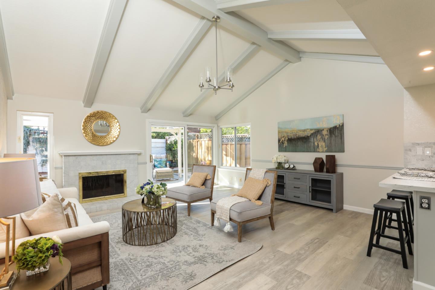4057 Ashbrook Circle San Jose, CA 95124 - Photo 5 of 15 a living room with furniture a fireplace and a flat screen tv