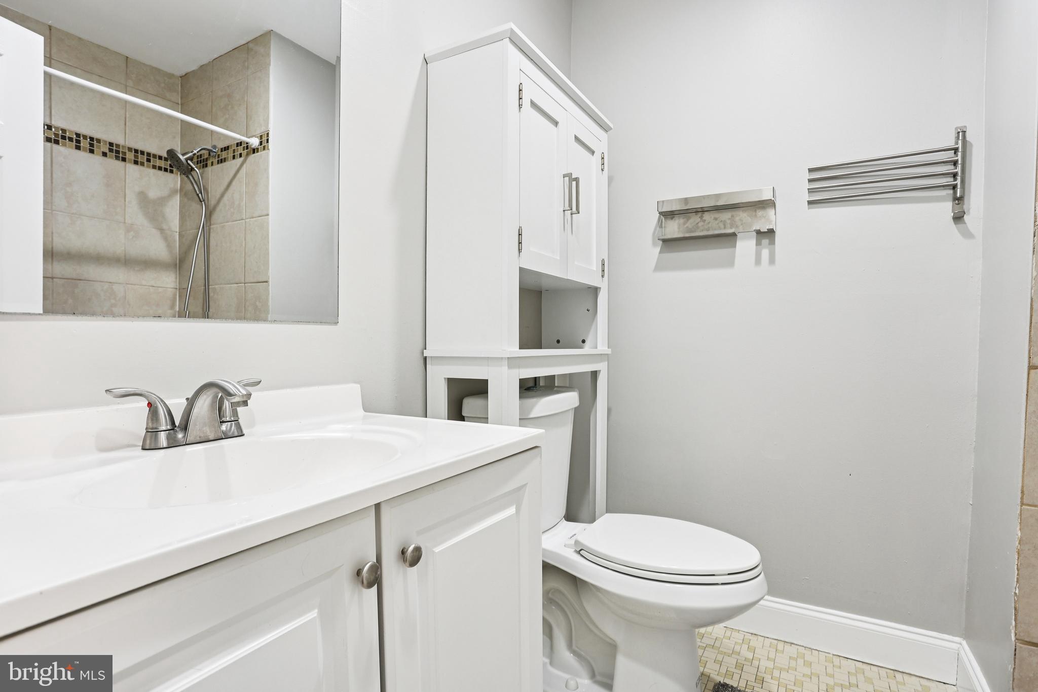 15 Brimfield Road Audubon, PA 19403 - Photo 15 of 41 a bathroom with a sink a toilet a mirror and shower