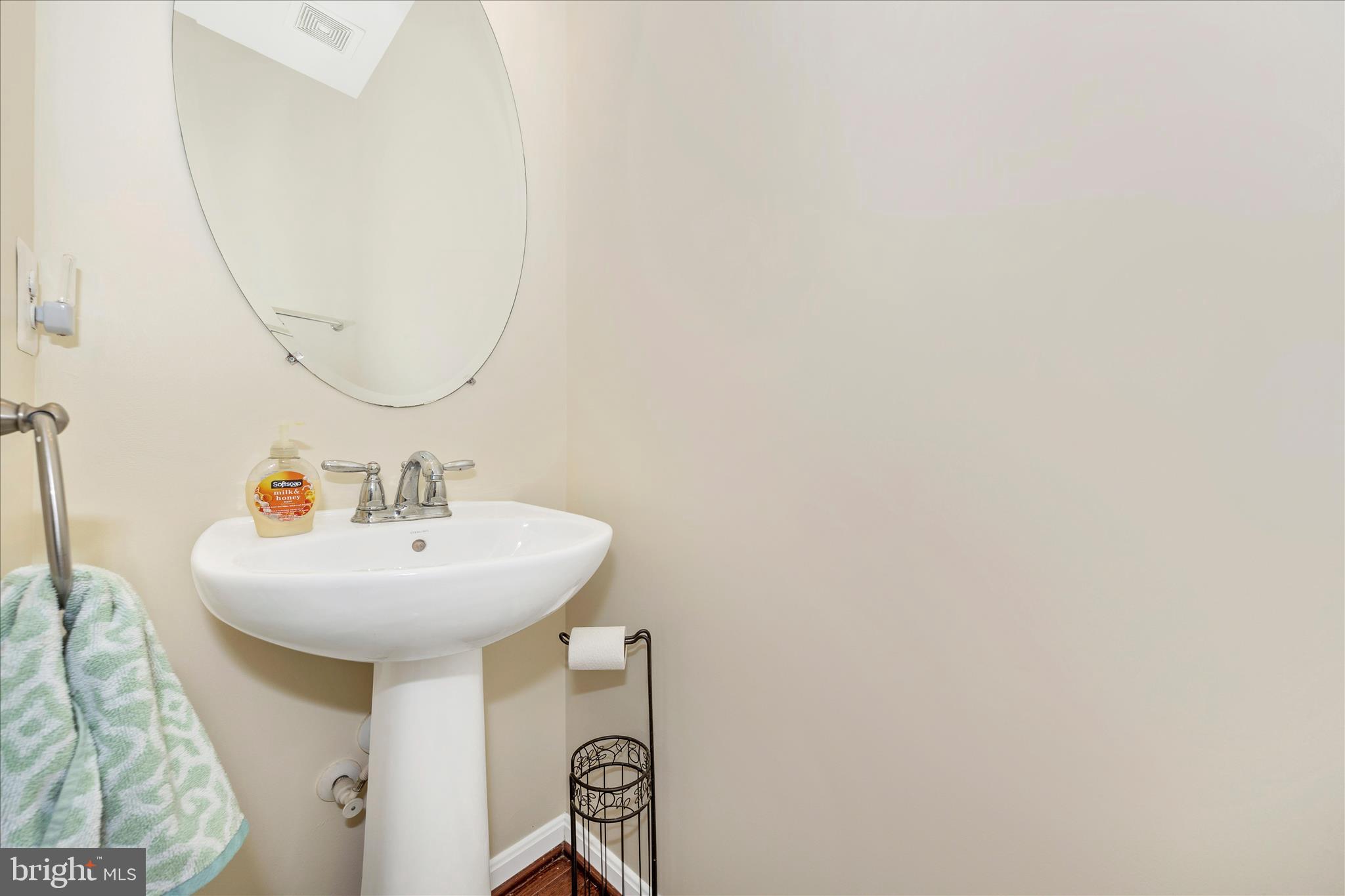 214 Union Ridge Drive Charles Town, WV 25414 - Photo 18 of 57 a bathroom with a sink a mirror and a wooden floor