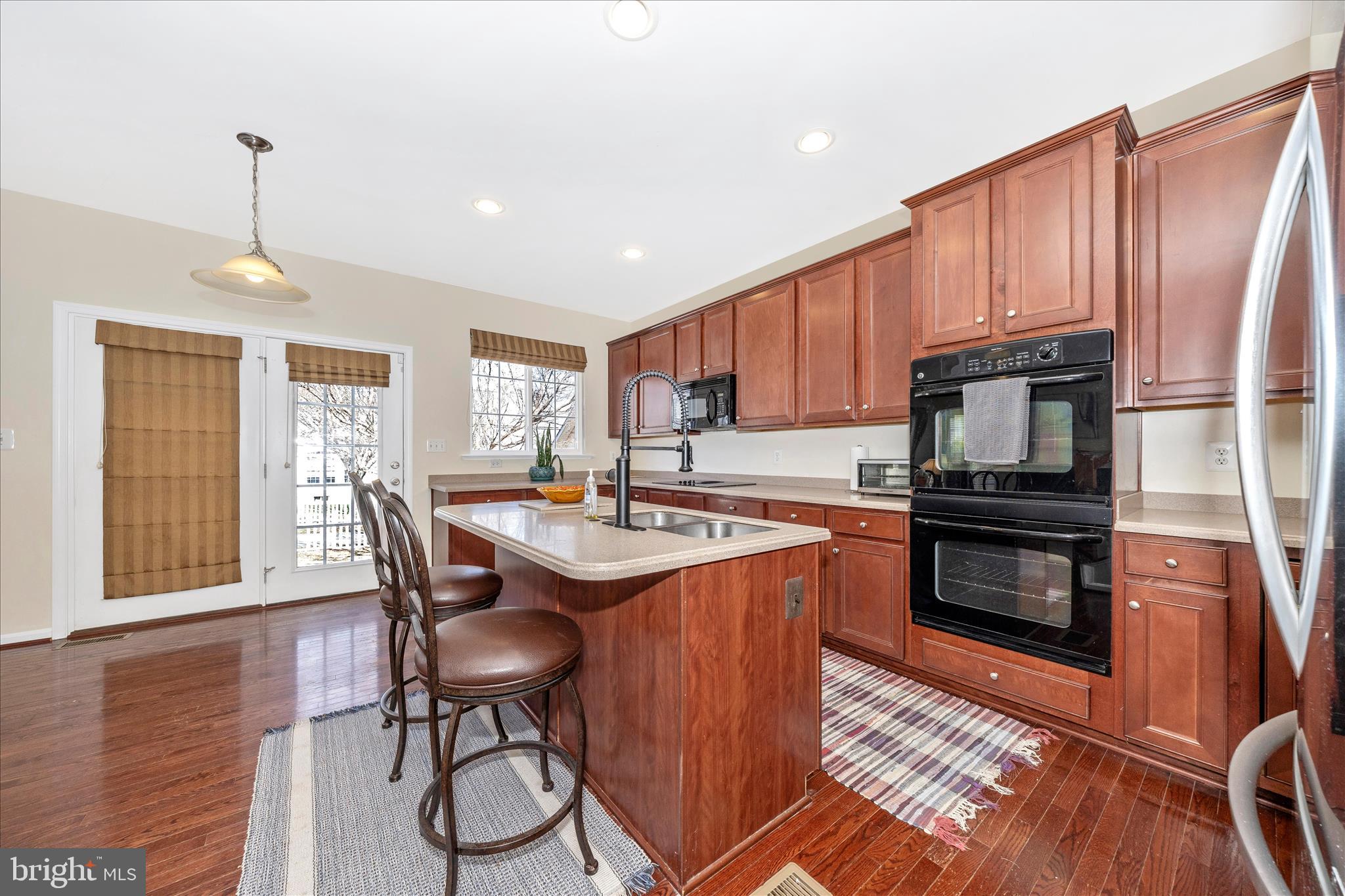 214 Union Ridge Drive Charles Town, WV 25414 - Photo 8 of 57 a kitchen with stainless steel appliances granite countertop a stove top oven a sink dishwasher a dining table and chairs with wooden floor