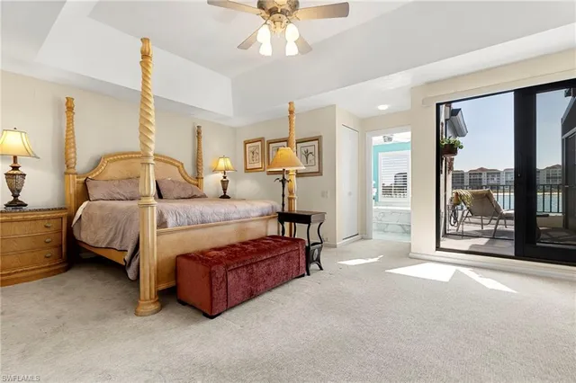 a spacious bedroom with a bed and large window