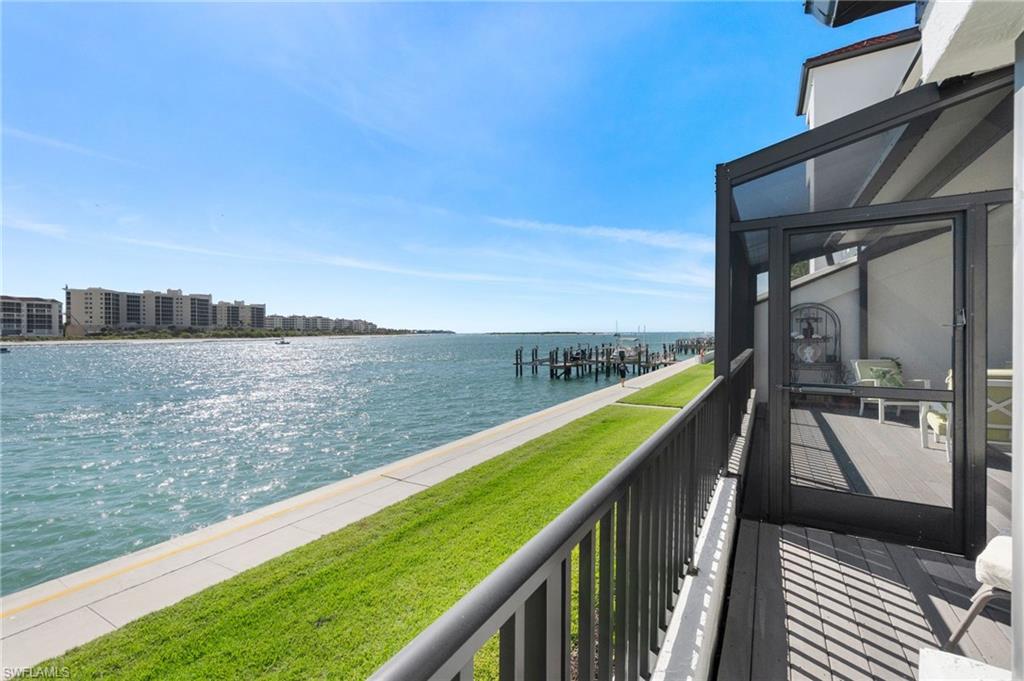 305 La Peninsula Boulevard, Unit 305 Naples, FL 34113 - Photo 16 of 23 a view of a balcony with an ocean