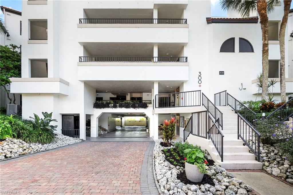 305 La Peninsula Boulevard, Unit 305 Naples, FL 34113 - Photo 2 of 23 a front view of a house with a yard