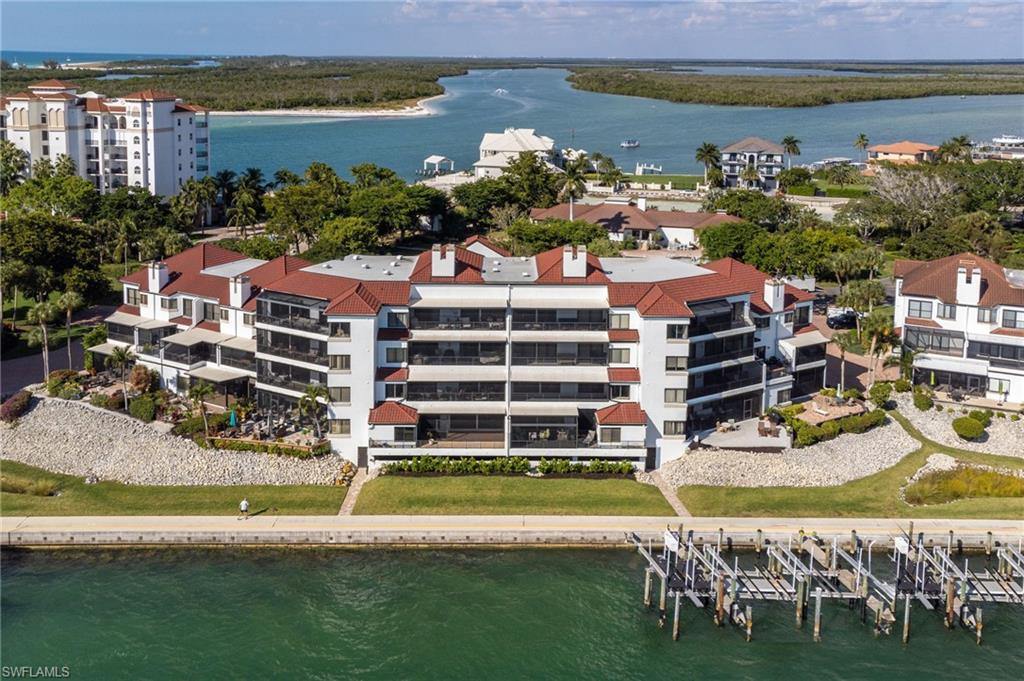 305 La Peninsula Boulevard, Unit 305 Naples, FL 34113 - Photo 4 of 23 a view of a city with lawn chairs