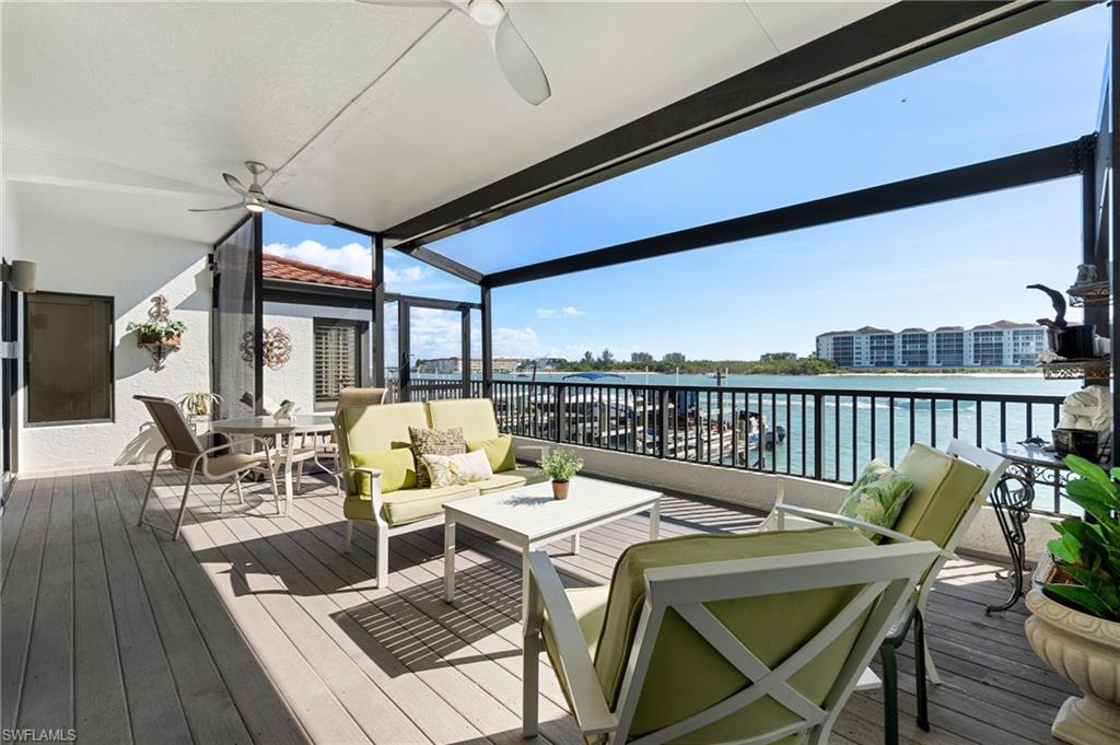 305 La Peninsula Boulevard, Unit 305 Naples, FL 34113 - Photo 6 of 23 a dining room with furniture and wooden floor