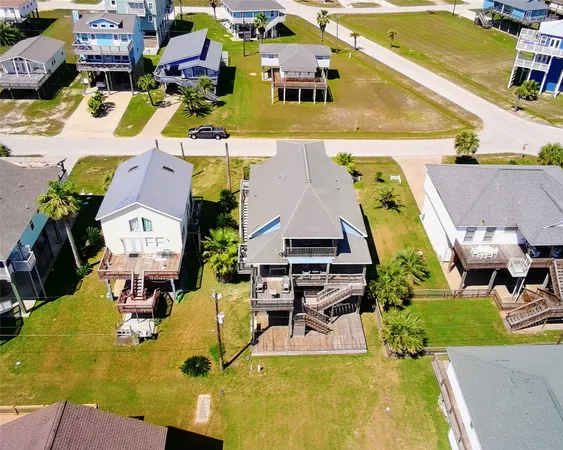 an aerial view of residential houses with outdoor space