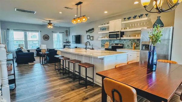 a kitchen with dining table and wooden floor