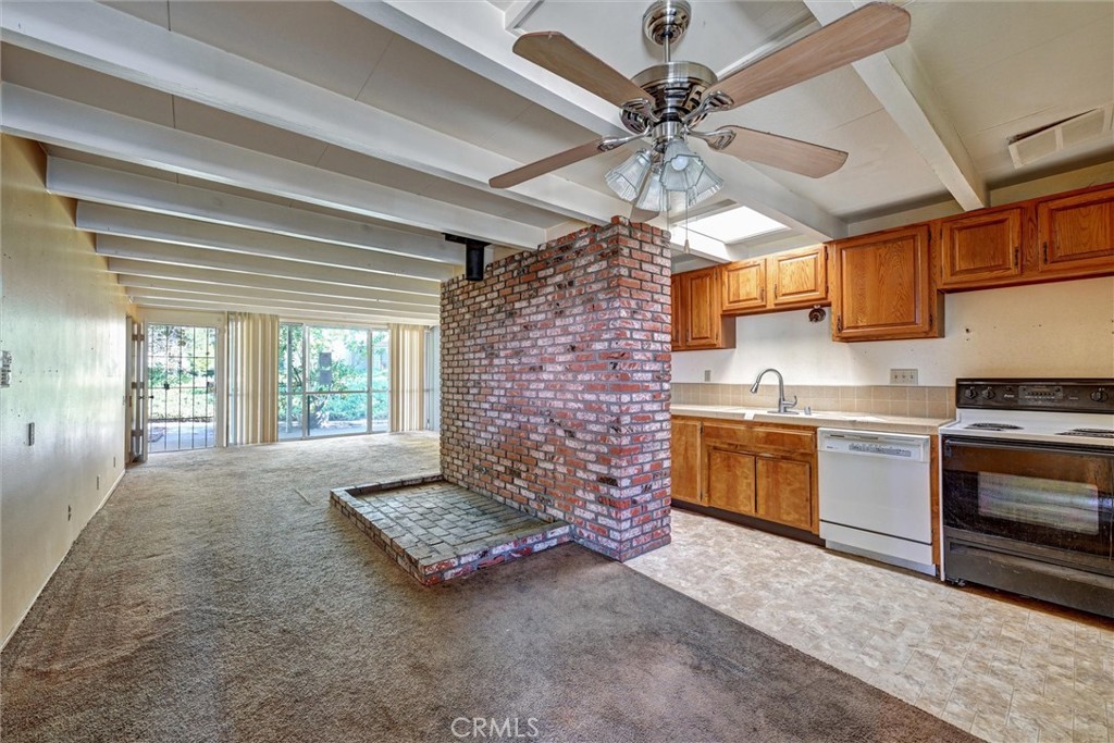604 Gibbel Road Hemet, CA 92543 - Photo 11 of 29 a kitchen with stainless steel appliances kitchen island granite countertop a stove a sink and a microwave