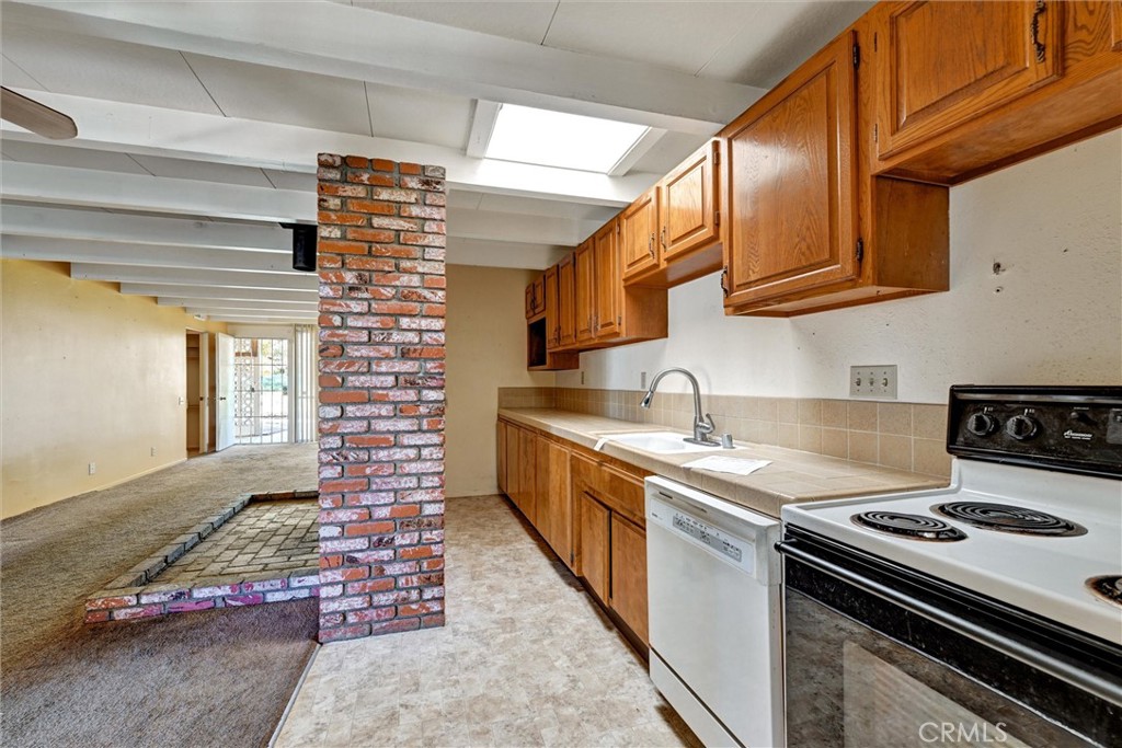 604 Gibbel Road Hemet, CA 92543 - Photo 13 of 29 a kitchen with stainless steel appliances granite countertop a stove a sink and dishwasher