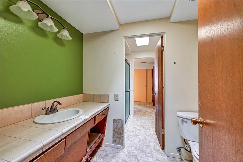 604 Gibbel Road Hemet, CA 92543 - Photo 19 of 29 a bathroom with a sink and a mirror