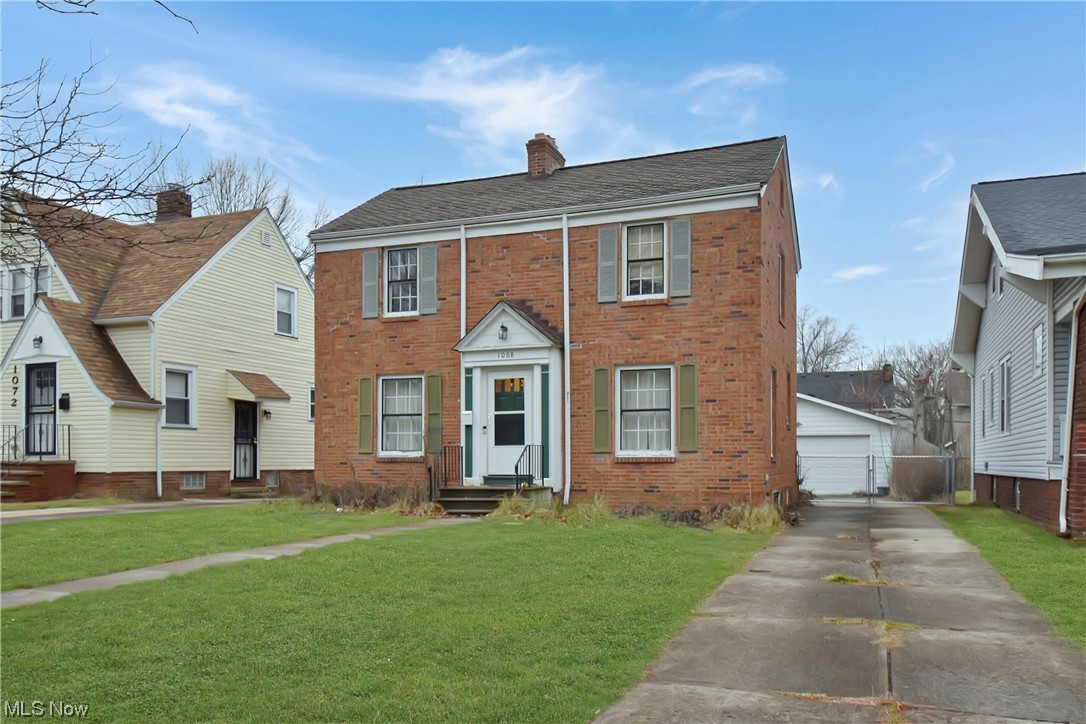 1068 Rushleigh Road Cleveland Heights, OH 44121 - Photo 22 of 22 View of front of house with a garage and a front lawn