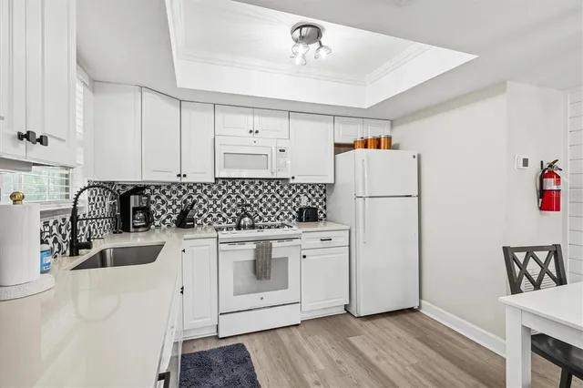 a bathroom with a granite countertop sink a toilet and shower