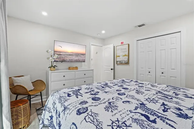 a living room with furniture a window and a potted plant