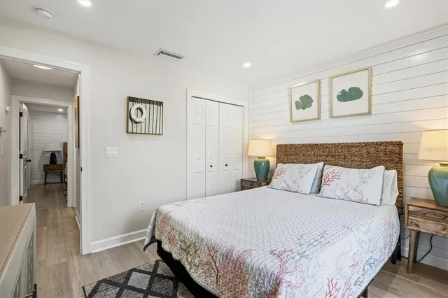 a living room with furniture wooden floor and kitchen view