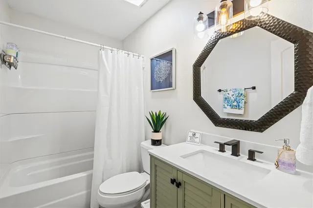 a kitchen with stainless steel appliances a table chairs and a chandelier