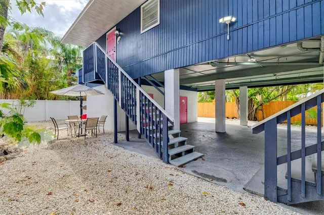 a bedroom with a bed table flowerpot and window